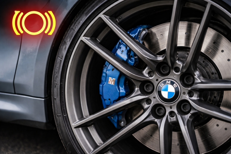 BMW brake pad warning light guide showing close-up brake and wheel area